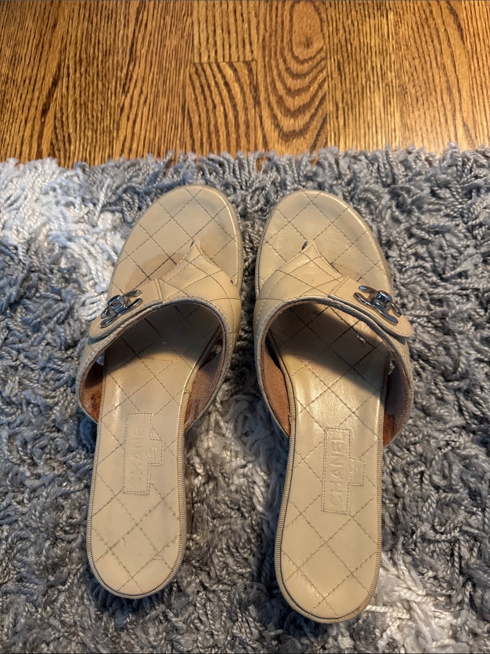 CHANEL Cream Quilted Leather Slide Mules with Logo Accent